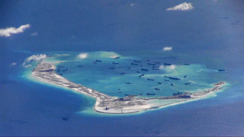 Chinese dredging vessels are purportedly seen in the waters around Mischief Reef in the disputed Spratly Islands in the South China Sea in this still image from video taken by a P-8A Poseidon surveillance aircraft provided by the US Navy