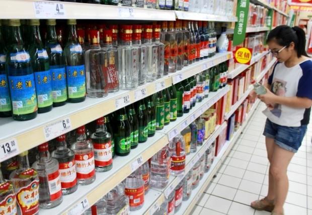 A woman holds a bottle of alcohol product at a supermarket in Nanjing Jiangsu Province China