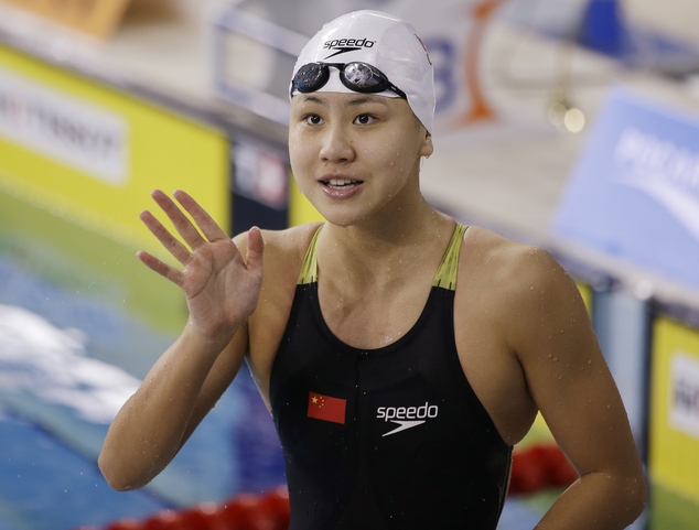 China's Chen Xinyi reacts after winning the women's 50m freestyle swimming final at the 17th Asian