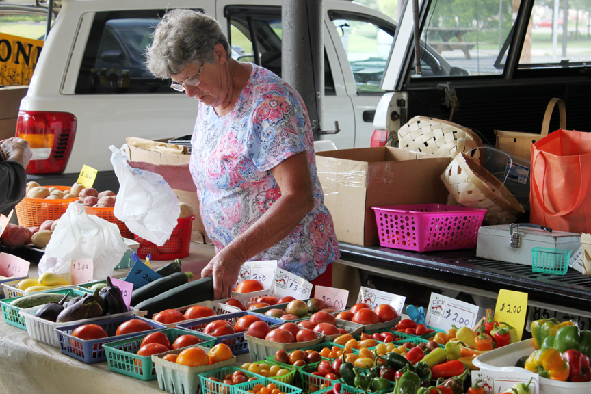 Wilma Cain helps a customer bag some cucumbers at the Lynchburg Farmer’s Market. The local farmers market is open each Friday from 3-6 p.m. at Moorehead Pavilion in Wiseman Park. Local producers set up and provide garden fresh produce and more to reside