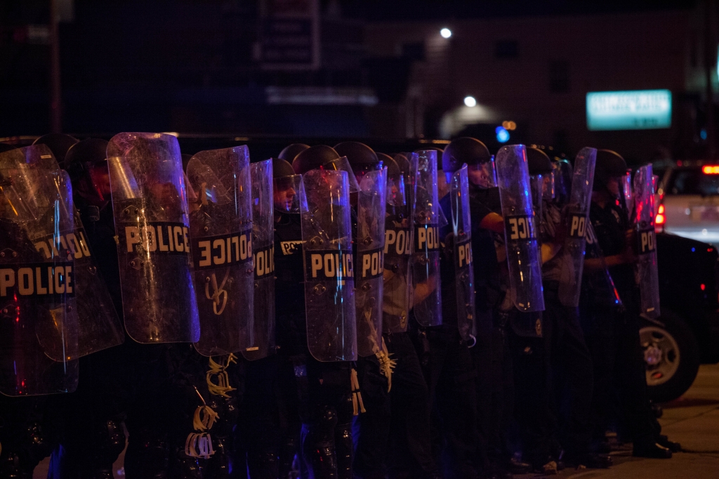 Police in riot gear line up as angry crowds took to the streets for a second night to protest an officer-involved killing