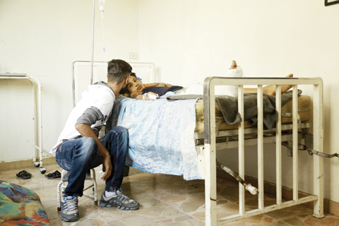 QAMISHLI Syria A wounded child lies in a hospital bed in this northeastern city yesterday a day after he was wounded in an airstrike by Syrian government forces against Kurdish positions over the flashpoint northeastern city of Hasakeh. — AFP