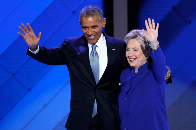 President Barack Obama and Democratic Presidential nominee Hillary Clinton wave to delegates after President Obama's speech during the third day of the Democratic National Convention in Philadelphia, Wednesday