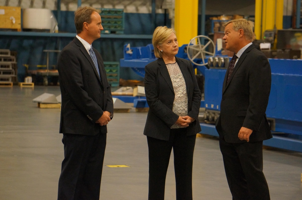 Democratic presidential nominee Hillary Clinton speaks with John Couch Vice President of Futuramic and Mark Jurcak President of Futuramic during tour of factory