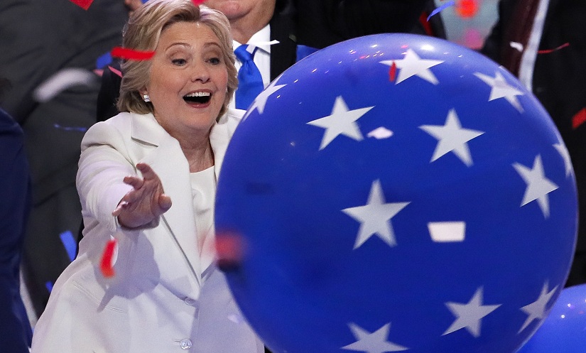 Democratic presidential nominee Hillary Clinton reaches for a falling balloon at the conclusion of the Democratic National Convention in Philadelphia, Thursday