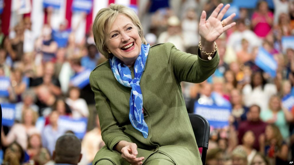 Democratic presidential candidate Hillary Clinton waves to members of the audience as she arrives at a rally at Adams City High School in Commerce City Colorado Aug. 3 2016