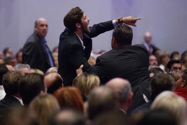 A demonstrator is led away as Republican presidential