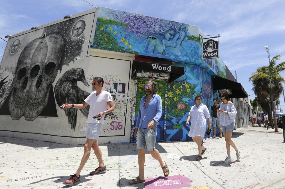 Visitors stroll through the Wynwood area Friday in Miami. Florida now reports 21 people have contracted the Zika virus in a 1-square-mile area encompassing Wynwood