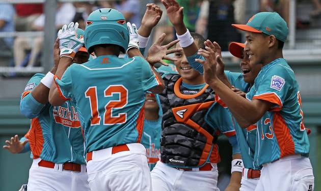 Panama's Joaquin Tejada celebrates with teammates after hitting a solo home run off Australia's Clayton Campbell during the second inning of an International pool play baseball game at the Little League World Series tournament in South Will