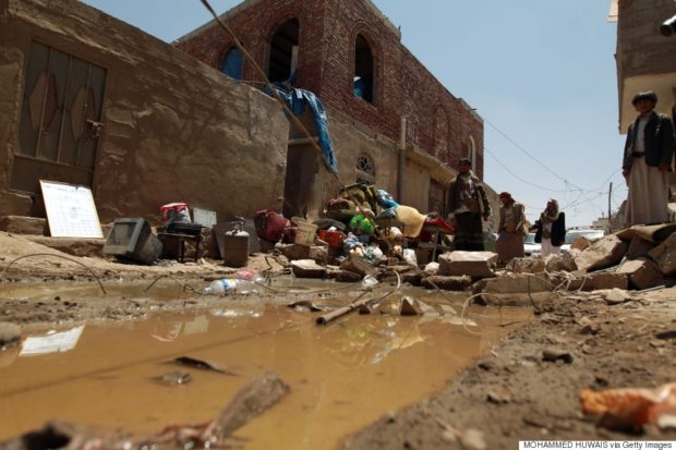 Yemenis gather near the rubble of houses near Sana’a Airport