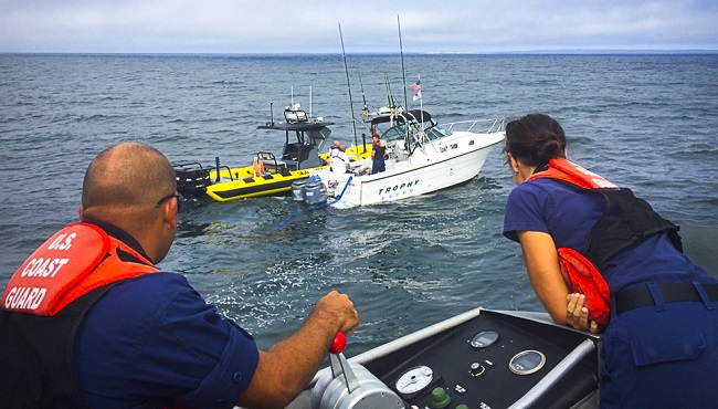 47-foot motor life boat crew members from Station Menemsha assist in engaging dewatering pumps aboard pleasure craft Fast Line approximately six miles off the southern coast of Martha’s Vineyard Mass