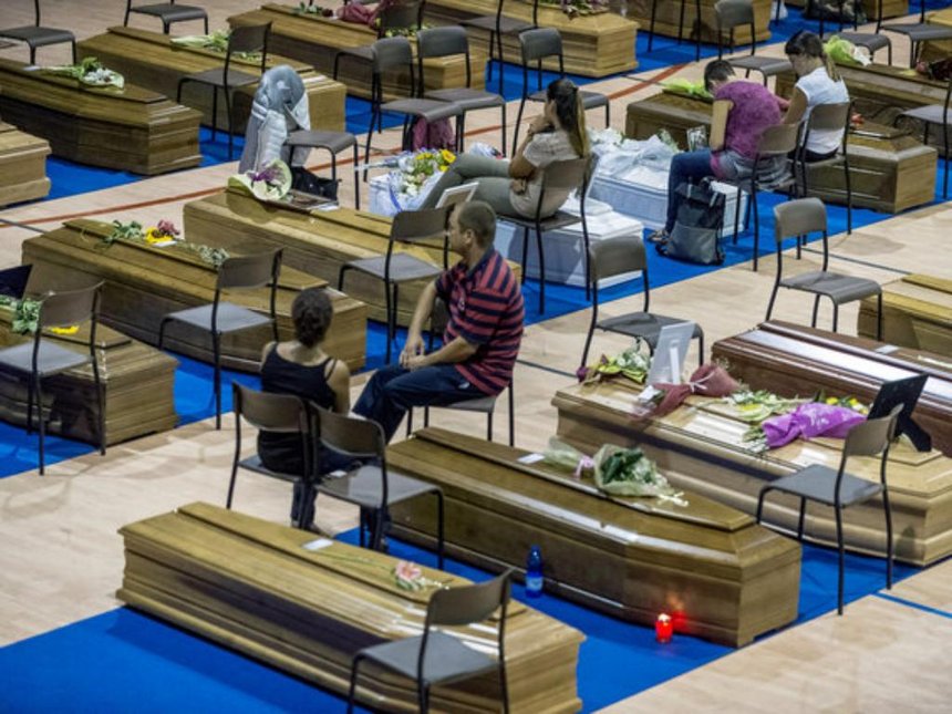 Coffins of some of the victims of the earthquake in central Italy are seen inside a gym in Ascoli Piceno