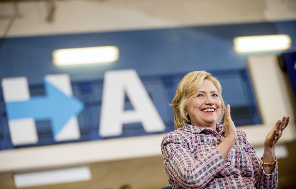 Democratic presidential candidate Hillary Clinton applauds as she sits on stage at a rally at Omaha North High Magnet School in Omaha Neb. on Aug. 1 2016