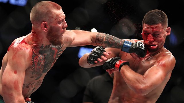 Conor Mc Gregor lands a punch on Nate Diaz at UFC 202