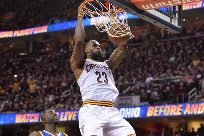 Cleveland Cavaliers forward Le Bron James dunks the ball in front of Golden State Warriors forward Draymond Green during the four quarter in game three of the NBA Finals at Quicken Loans Arena. Mandatory Credit Ken Blaze-USA TODAY Sports