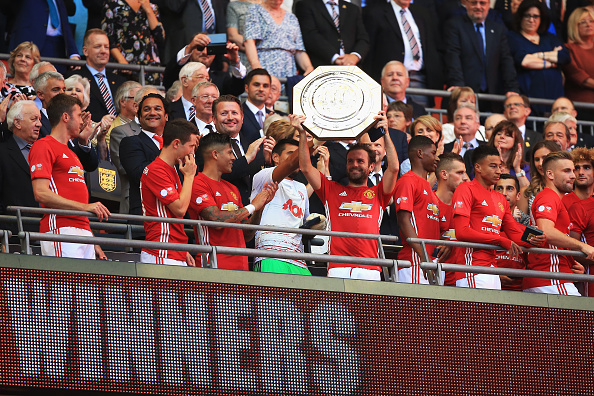 LONDON ENGLAND- AUGUST 07 Juan Mata of Manchester United lifts the Community Shield trophy during The FA Community Shield match between Leicester City and Manchester United at Wembley Stadium