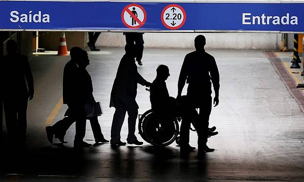 Controversey Pat Hickey is escorted by police in a wheelchair at the Hospital Samaritano in Rio de Janeiro