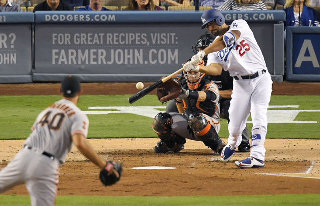 Los Angeles Dodgers Rob Segedin right hits a solo home run off San Francisco Giants starting pitcher Madison Bumgarner left as catcher Buster Posey watc