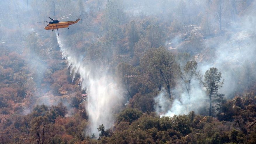 A work crew from the California Conservation Corps Butte County Fire Center cuts a line on Black Mountain near the town of Tollhouse Calif. while fighting a blaze Monday Aug. 1 2016