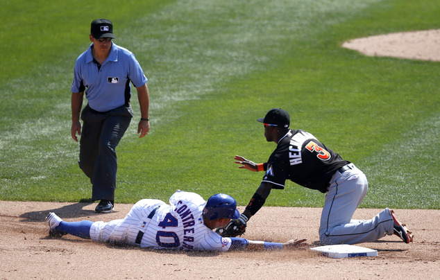 Chicago Cubs Willson Contreras steals second on a throw from Miami Marlins catcher Jeff Mathis to shortstop Adeiny Hechavarria as umpire Mark Wegner watche