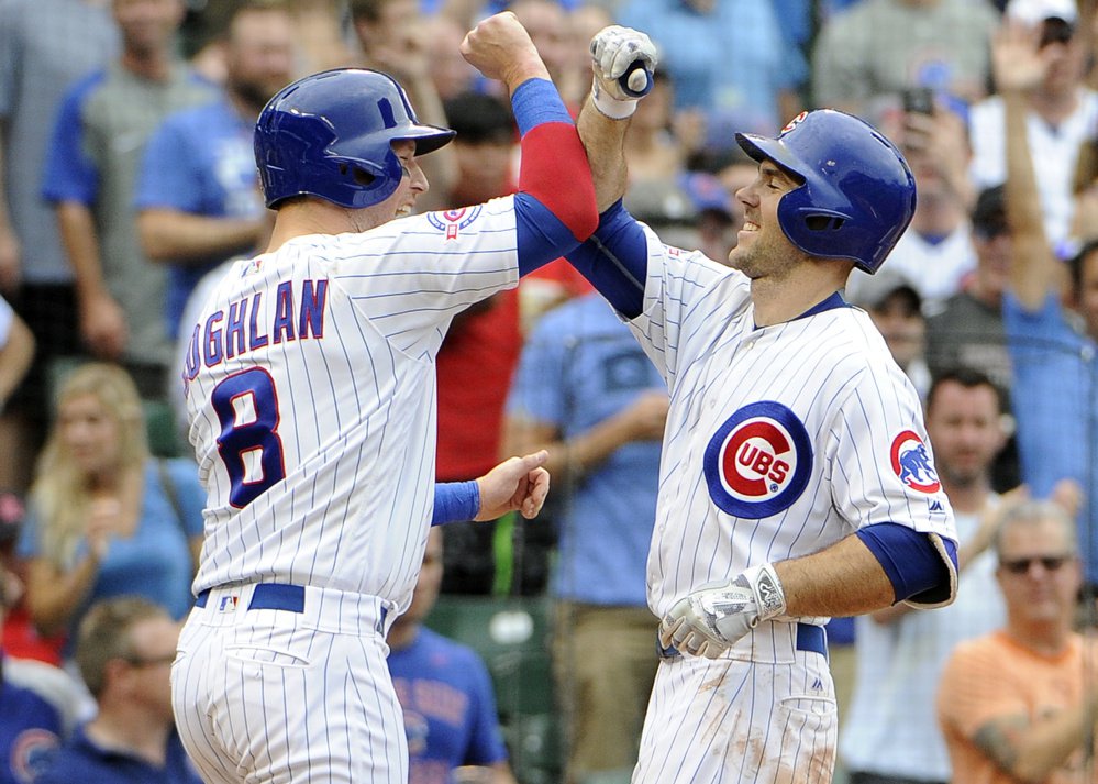 Chicago's Matt Szczur right is greeted by Chris Coghlan after hitting a two-run homer against the St. Louis Cardinals during the seventh inning of Chicago's 13-2 victory on Friday