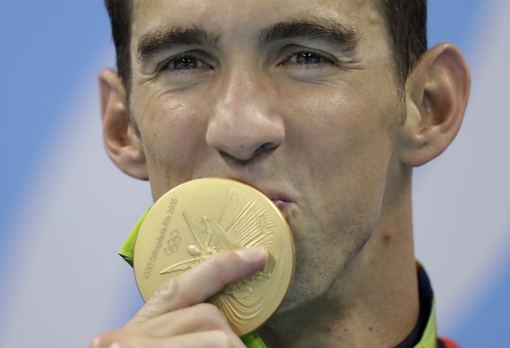 United States&apos Michael Phelps kisses his gold medal after the men's 4x100-meter freestyle final during the swimming competitions at the 2016 Summer Olympics Monday Aug. 8 2016 in Rio de Janeiro Brazil