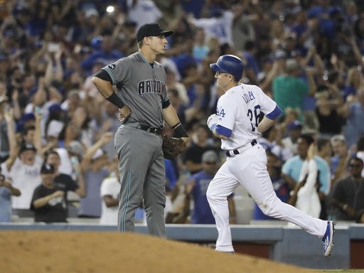 Los Angeles Dodgers Chase Utley right rounds the bases past Arizona Diamondbacks third baseman Jake Lamb after hitting a two-run home run during the seventh inning of a baseball game Friday