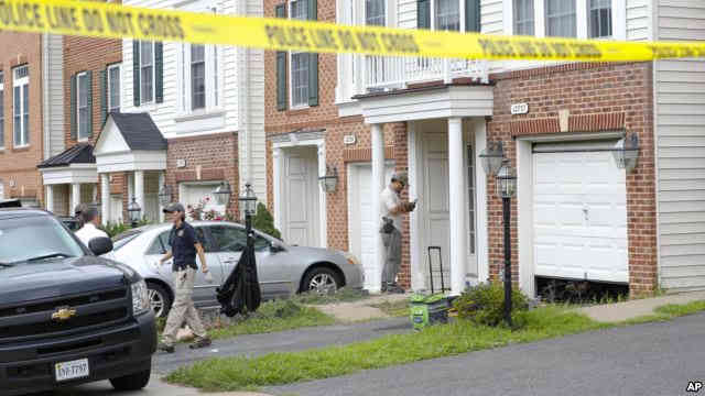 Law enforcement officers are seen outside the home of Nicholas Young a Washington Metro Transit Officer Aug. 3 2016 in Fairfax Virginia  Credit VOA News