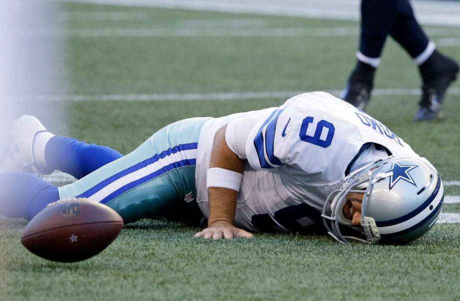 Dallas Cowboys quarterback Tony Romo lies on the turf after he went down on a play against the Seattle Seahawks during the first half of a preseason NFL football game Thursday Aug. 25 2016 in Seattle