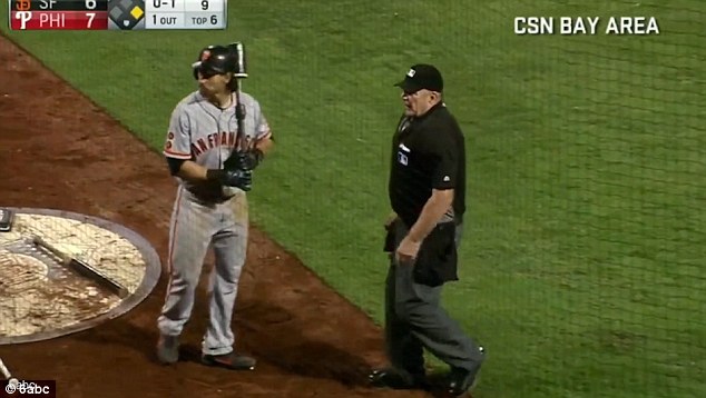 Davidson walks past Giants outfielder Angel Pagan- who was batting- to find the fan who had been hollering'You suck! at him