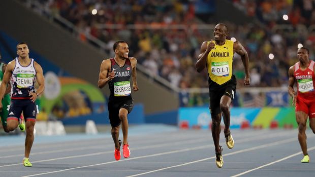 De Grasse looks at Bolt as he gains on the Jamaican sprinter