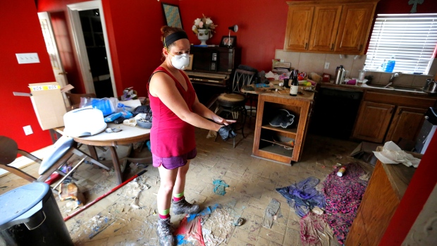 Johnette Folse stands in her flood damaged kitchen in Denham Springs La. on Tuesday. Historic floods in the state have destroyed more than 40,000 homes