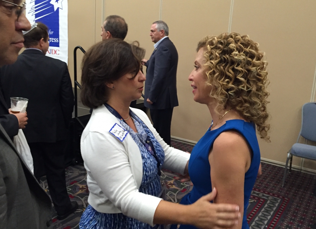 Debbie Wasserman Schultz right gets a hug at a National Jewish Democratic Council reception