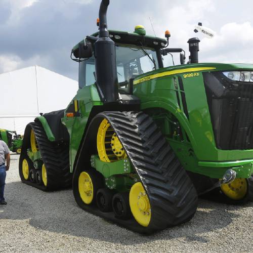 Douglas and Monika Johnson from Perry Iowa look at John Deere equipment on display at the Farm Progress Show in Decatur Ill. Deere & Co. report financial results Friday Aug. 19 2016. (AP