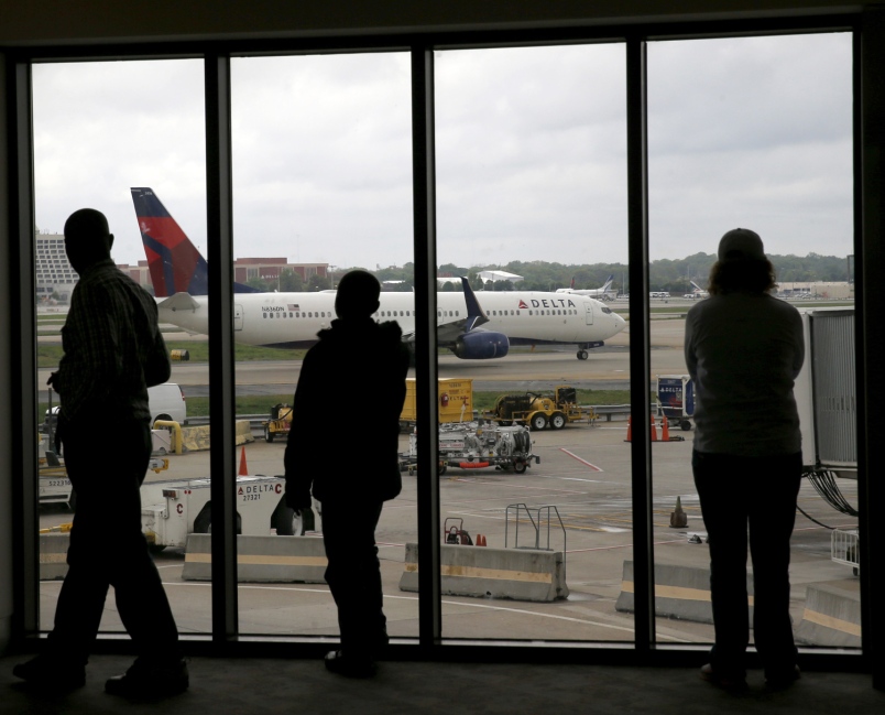 Delta Air Lines passengers watch a plane taxi at Atlanta's Hartsfield International Airport in Atlanta in April 2015. Delta Air Lines grounded flights scheduled to leave Monday Aug. 8 2016 after experiencing unspecified systems issues. Charles Rex