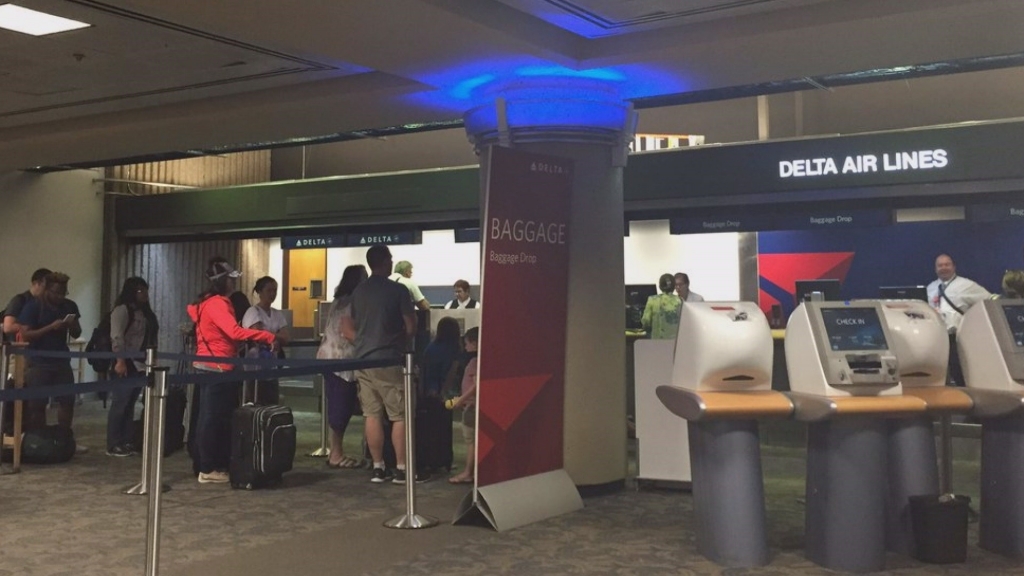 Delta passengers wait at Sky Harbor to see if their Tuesday morning flights are delayed