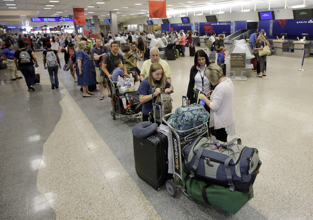 Delta passengers stand in line as the carrier slogged through day two of its recovery from a global computer