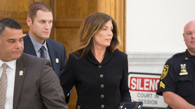 Pennsylvania Attorney General Kathleen Kane escorted by members of her security team prepares to leave the Montgomery County Courthouse and await a verdict in Norristown Pa. Monday Aug. 15 2016