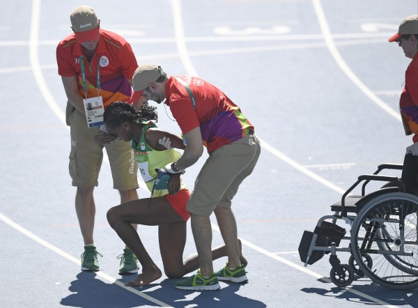 Ethiopia's Etenesh Diro is helped from the track after a women's 3000-meter steeplechase heat during the athletics competitions of the 2016 Summer Olympics at the Olympic stadium in Rio de Janeiro Brazil Saturday Aug. 13 2016