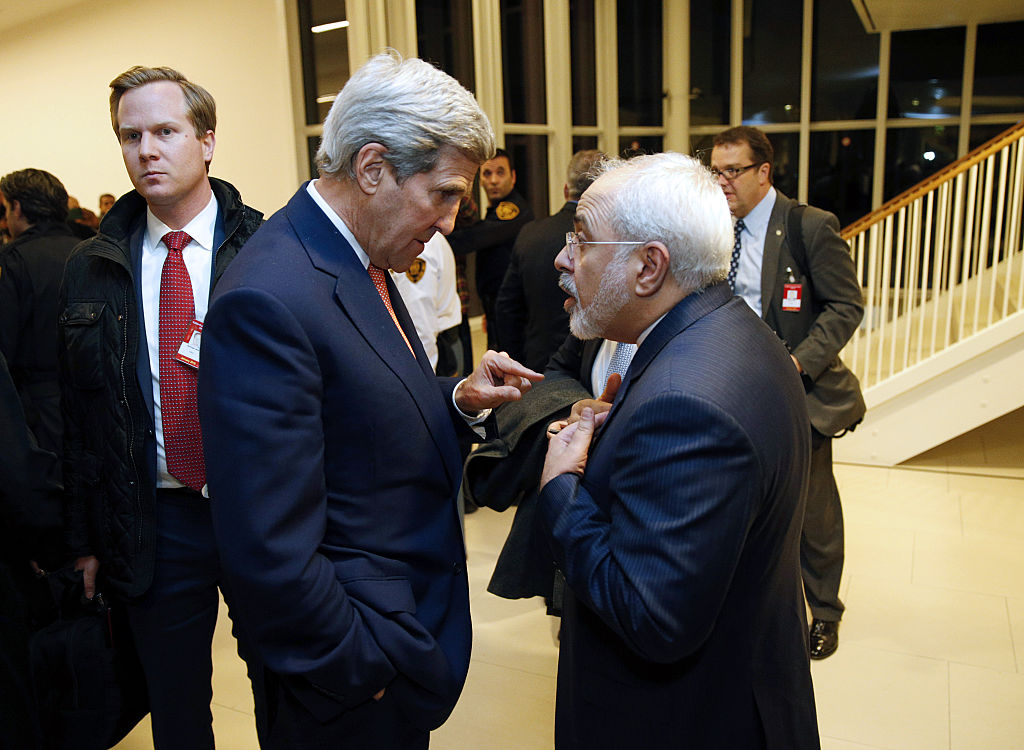 Secretary of State John Kerry speaks with Iranian Foreign Minister Mohammad Javad Zarif after the International Atomic Energy Agency verified that Iran has met all conditions under the nuclear deal during the E3/EU+3 and Iran talks in Vienna