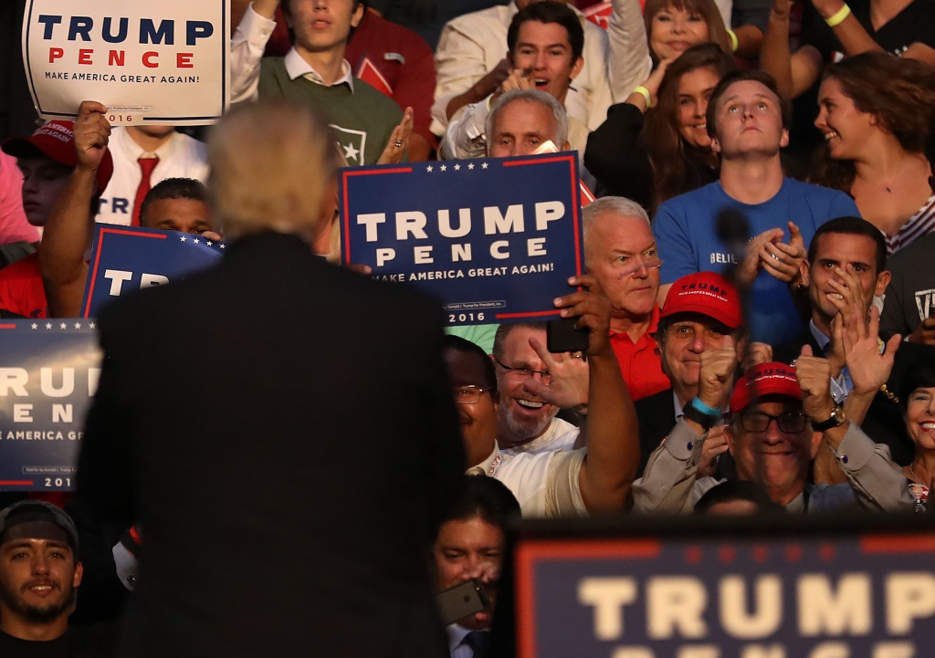 Former Congressman Mark Foley sits in the audience as Republican presidential nominee Donald Trump looks back at the crowd during his campaign event at the BB&T Center