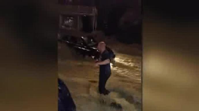 WATCH: Men form human chain to save woman from Maryland floods