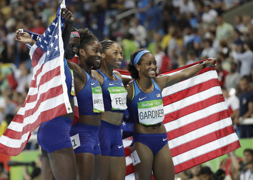 The United States team from left Tori Bowie Tianna Bartoletta Allyson Felix and English Gardner celebrate winning the gold medal in the women's 4x100-meter relay final during the athletics competitions of the 2016 Summer