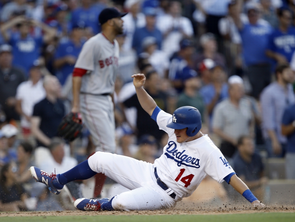 Los Angeles Dodgers&#039 Enrique Hernandez right scores as the throw to Boston Red Sox catcher gets cutoff as David Price looks away left during the fifth inning of a baseball game in Los Angeles Sunday Aug. 7 2016