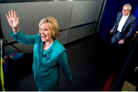 Democratic presidential candidate Hillary Clinton accompanied by Sen. Harry Reid D-Nev. right arrives to speak at a rally at International Brotherhood of Electrical Workers Local 357 Hall in Las Vegas Thursday Aug. 4 2016