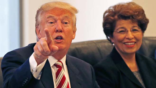 Republican presidential candidate Donald Trump holds a Hispanic advisory roundtable meeting in New York Saturday Aug. 20 2016. At right is Jovita Carranza former Small Business Administration Deputy Administrator