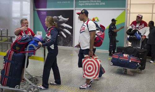 Members of the Russian Olympic delegation wheel past with their luggage after arriving at the Rio de Janeiro International Airport to compete at the 2016 Summer Olympics in Rio de Janeiro Brazil