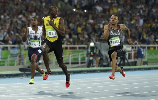 Jamaica's Usain Bolt looks to Canada's Andre De Grasse right during a men's 100-meter semifinal during the athletics competitions in the Olympic stadium of the 2016 Summer Olympics in Rio de Janeiro Brazil Sunday Aug. 14 2016