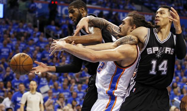 Oklahoma City's Steven Adams gets tangled with San Antonio's La Marcus Aldridge, left and Danny Green during Game 6 of the Western Conference semifinals between the Oklahoma City Thunder and the San Antonio Spurs in the NBA playof