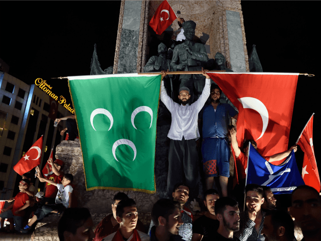 Pro Erdogan supporters hold Turkish national and Ottoman flags during a rally at Taksim square i istanbull